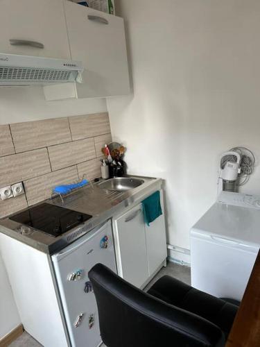 uma pequena cozinha com um lavatório e um fogão em Studio equipé, lumineux a Paris em Paris