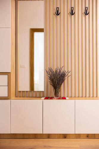 a white dresser with a mirror and a vase at Villa Florale in Široka