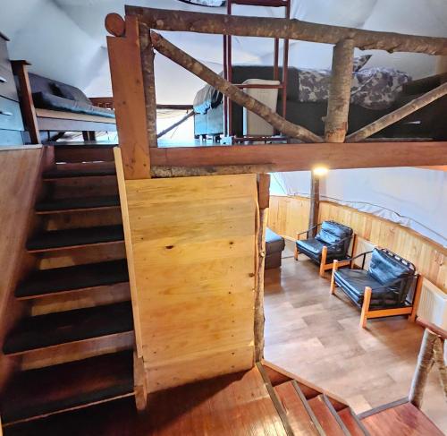 an overhead view of a room with stairs and chairs at Vortice Chile Eco-Lodge in Manzanar