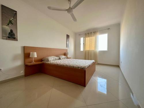 a bedroom with a bed and a ceiling fan at Cidade Velha - Cathedral and Sea view - 1Bdr Apart - 2 in Cidade Velha