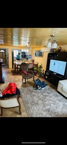 a living room with a flat screen tv and a living room at Casa mantul in Parral