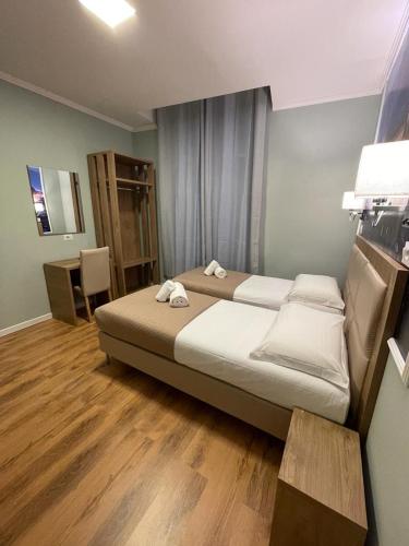 a bedroom with a bed with two towels on it at Titta & Ruffo in Pisa