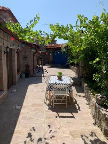 a patio with a table with a potted plant on it at Olive Ranch Guest House in Bergas