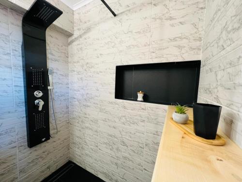 baño con TV en la pared y barra en Central Studio 28, en Sinaia