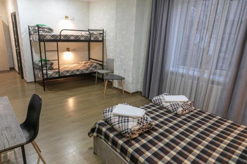 a room with two bunk beds and a table at Alina Hotel & Hostel in Uzhhorod