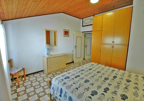 ein Schlafzimmer mit einem Bett und einer Kommode darin in der Unterkunft CASA CECILIA in Marina di Campo