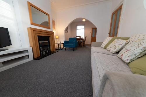 a living room with a couch and a television at Hampton House in Stockton-on-Tees