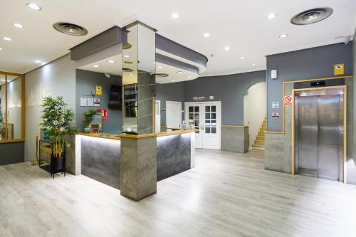 an empty lobby with a counter in a building at VTZ Hotel El Príncipe in Zaragoza