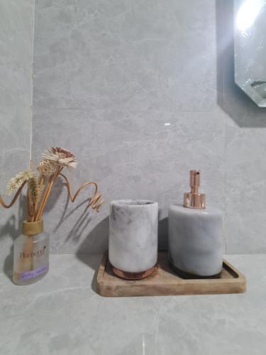 a couple of candles sitting on a wooden shelf at Merpati inn hotel in Dompu