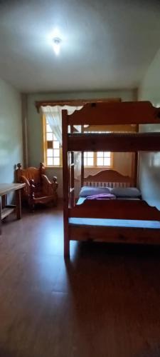a bedroom with a bunk bed in a room at Azaeleas Lodging House in Sagada