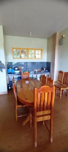 a dining room with a wooden table and chairs at Azaeleas Lodging House in Sagada