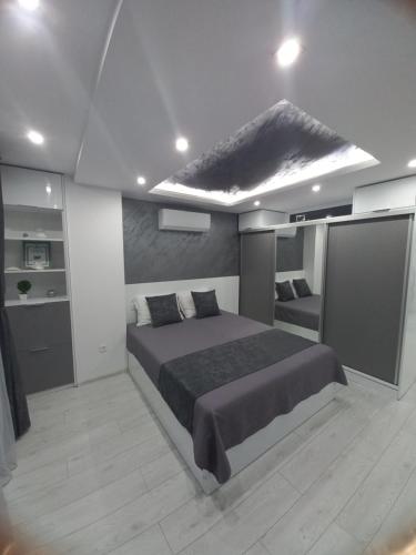 a bedroom with a large bed in a room at Apartment Krisiya in Burgas in Burgas City