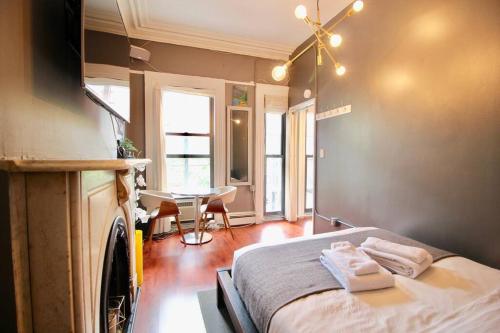 a bedroom with a bed with two towels on it at The West Village Gem in New York