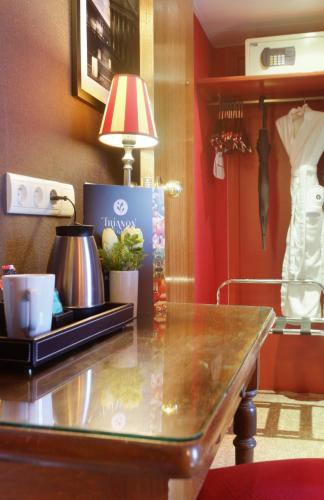 a table with a lamp on top of it at Hotel Trianon Rive Gauche in Paris