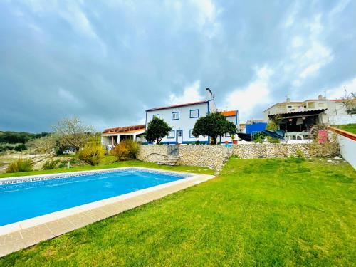 a villa with a swimming pool and a house at Casa da Horta in Canha