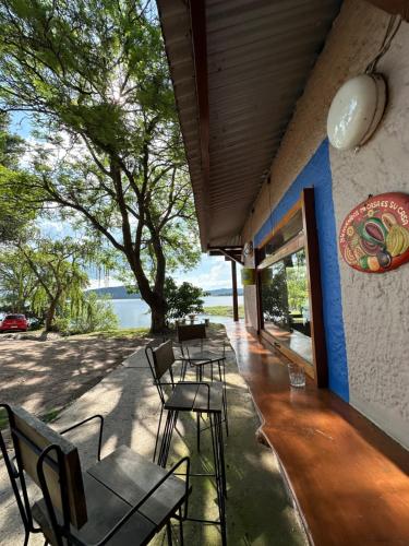 a restaurant with chairs and tables and a view of the water at Casa del lago in Embalse