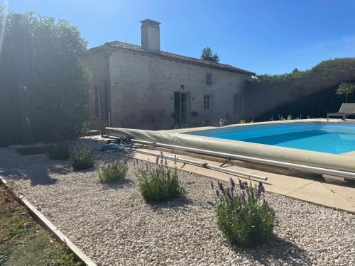a large swimming pool in front of a building with at Le Reve de Breuillac in Surin