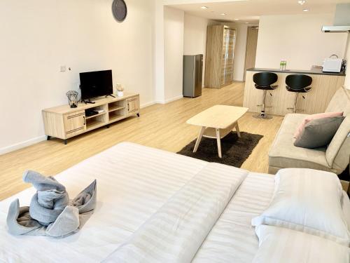 a living room with a large bed and a couch at Deco Home @ Aru Suites in Kota Kinabalu