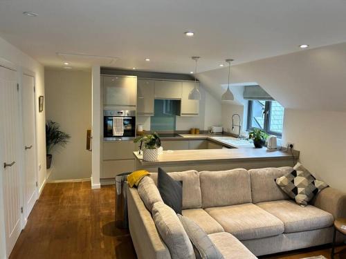 a living room with a couch and a kitchen at Flat in Budleigh Salterton in Budleigh Salterton