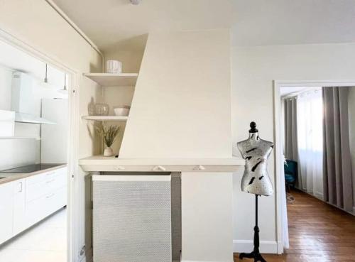 a kitchen with white cabinets and a mannequin in a room at Suite Topaze by STACK  in Lyon