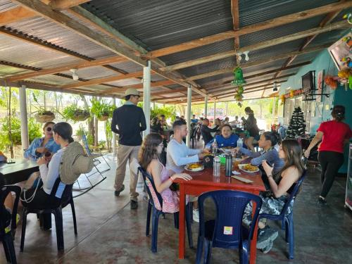 a group of people sitting at a table in a restaurant at Hostal Sol de Verano Doña Lilia in Villavieja