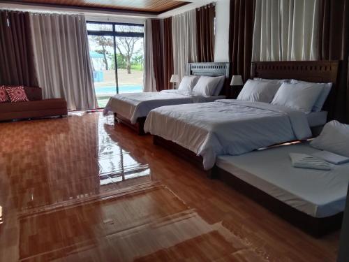 a hotel room with two beds and a window at Saffire Beach Resort and Glamping in Pagudpud