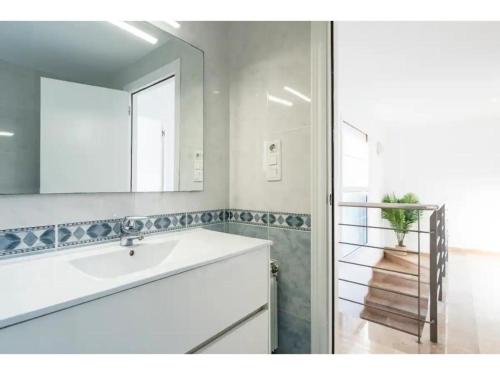 a bathroom with a white sink and a mirror at Villa Mora 2 Pool Oasis in La Mora