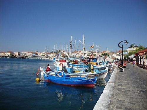 a group of boats are docked in a harbor at Kallirroi Studios in Pythagoreio