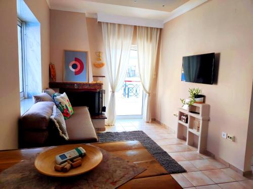 a living room with a couch and a tv at Golden Sky 1 Apartment by Daniela in Perea