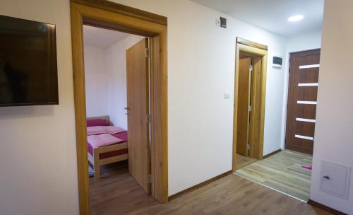 a room with a door leading to a bedroom at Mountain Mirage in Mojkovac