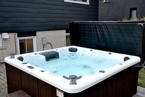 a jacuzzi tub in the backyard of a house at Cellar House NOTL - Entire Home in the Heart of Niagara-on-the-Lake in Niagara on the Lake
