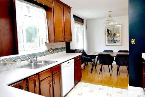 a kitchen with a sink and a table with chairs at Cellar House NOTL - Entire Home in the Heart of Niagara-on-the-Lake in Niagara on the Lake