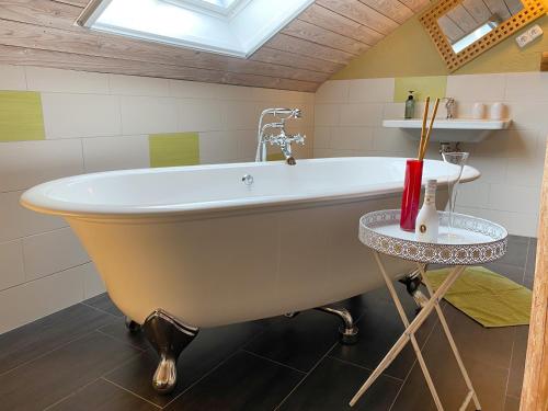 a bath tub in a bathroom with a skylight at Hof Sorgenlos in Groß Gievitz
