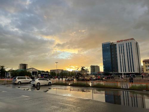 a city with cars parked in a parking lot at Omar’s place in Ölgiy