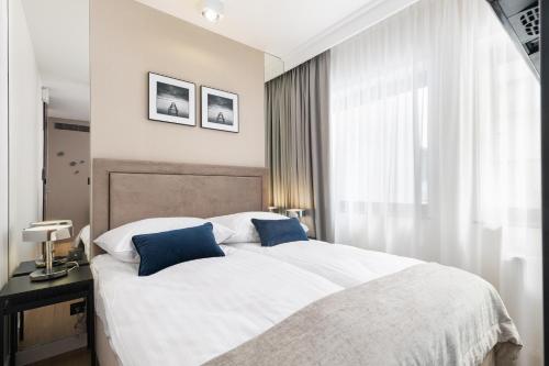 Posteľ alebo postele v izbe v ubytovaní Apartamenty Deo Plaza - Old Town by Rent like home
