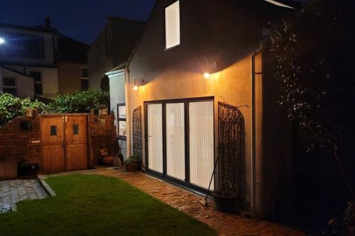a house with a gate in the yard at night at Heart of Easton in Bristol