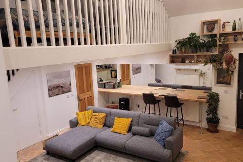 a living room with a couch with yellow pillows at Heart of Easton in Bristol