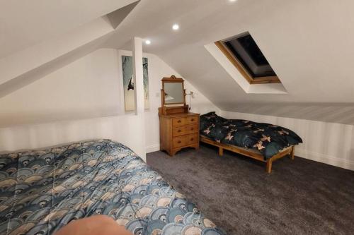 a bedroom with a bed and a dresser with a mirror at Heart of Easton in Bristol