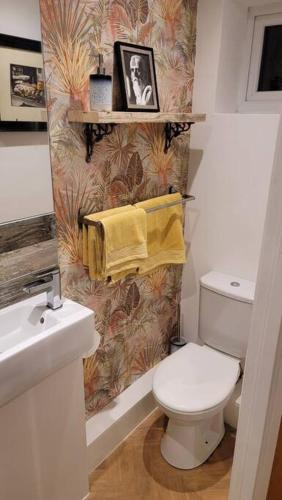 a bathroom with a white toilet and a sink at Heart of Easton in Bristol