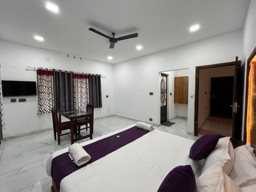 a bedroom with a large bed and a desk at Mount court munnar in Munnar