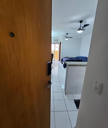 an open door to a kitchen with a bed at Edifício Belluno in Ribeirão Preto