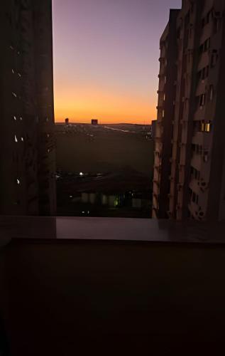 a sunset seen from a window in a city at Edifício Belluno in Ribeirão Preto