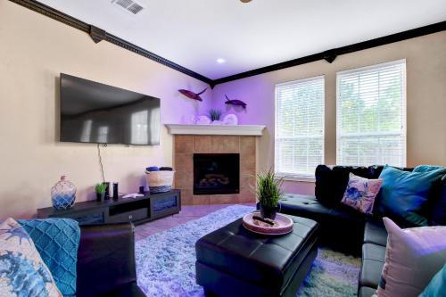a living room with a couch and a fireplace at Aqueous - A Birdy Vacation Rental in San Antonio