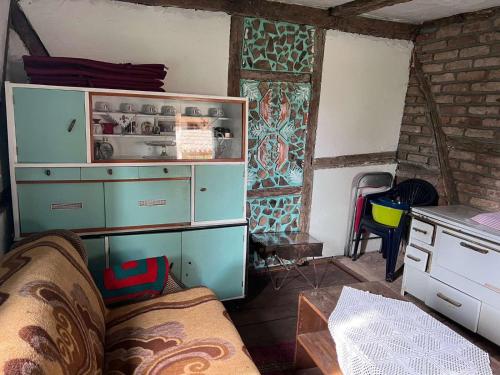 a living room with a cabinet and a couch at Vikendica Pantic in Bijeljina