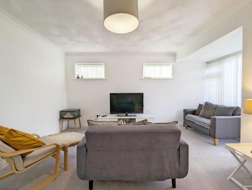 a living room with a couch and a tv at Marine Lodge in Bognor Regis