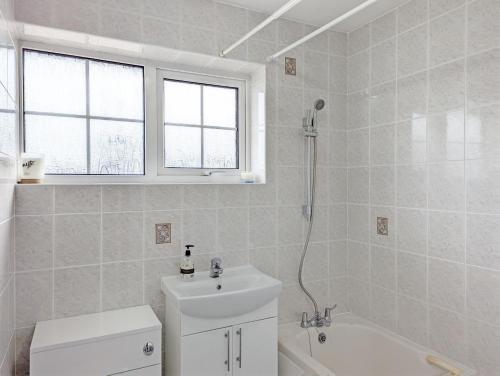 a white bathroom with a sink and a toilet at Marine Lodge in Bognor Regis