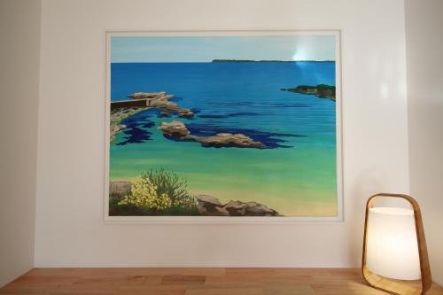 a framed painting of the ocean on a wall at Maison neuve proche de la plage 3 chambres / accès PMR / Parking in Ploemeur