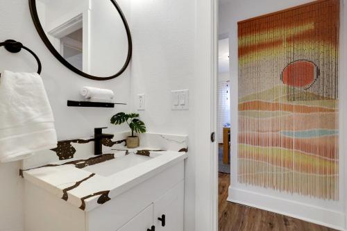 a bathroom with a sink and a mirror at Artsy - A Birdy Vacation Rental in San Antonio