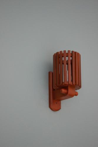 a brown wooden object on a white wall at URALSURF HOUSE in Weligama