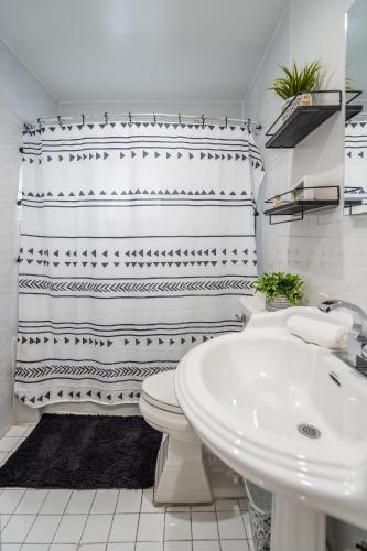 a bathroom with a white toilet and a sink at 2 BD Home w/ Private Parking, Private Yard & W/D in Miami